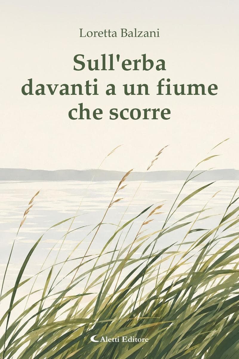 Sull'erba davanti a un fiume che scorre